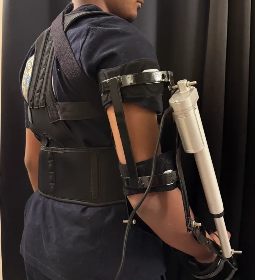 Fit test: the worn frame anchored at the shoulder and waist, checked for pressure points and range of motion